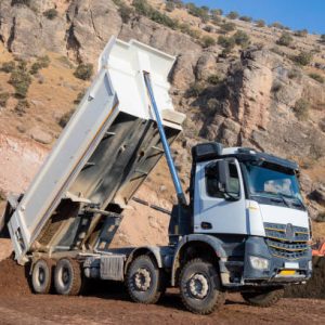 White Dump truck unloading soil